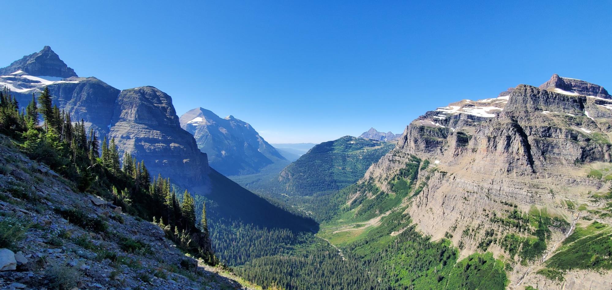 a view of a valley with mountains in the background