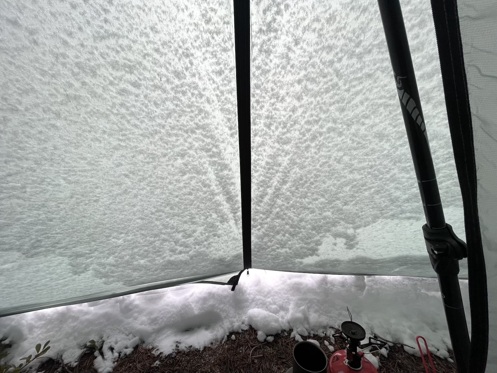 the inside of a tent with snow on the ground