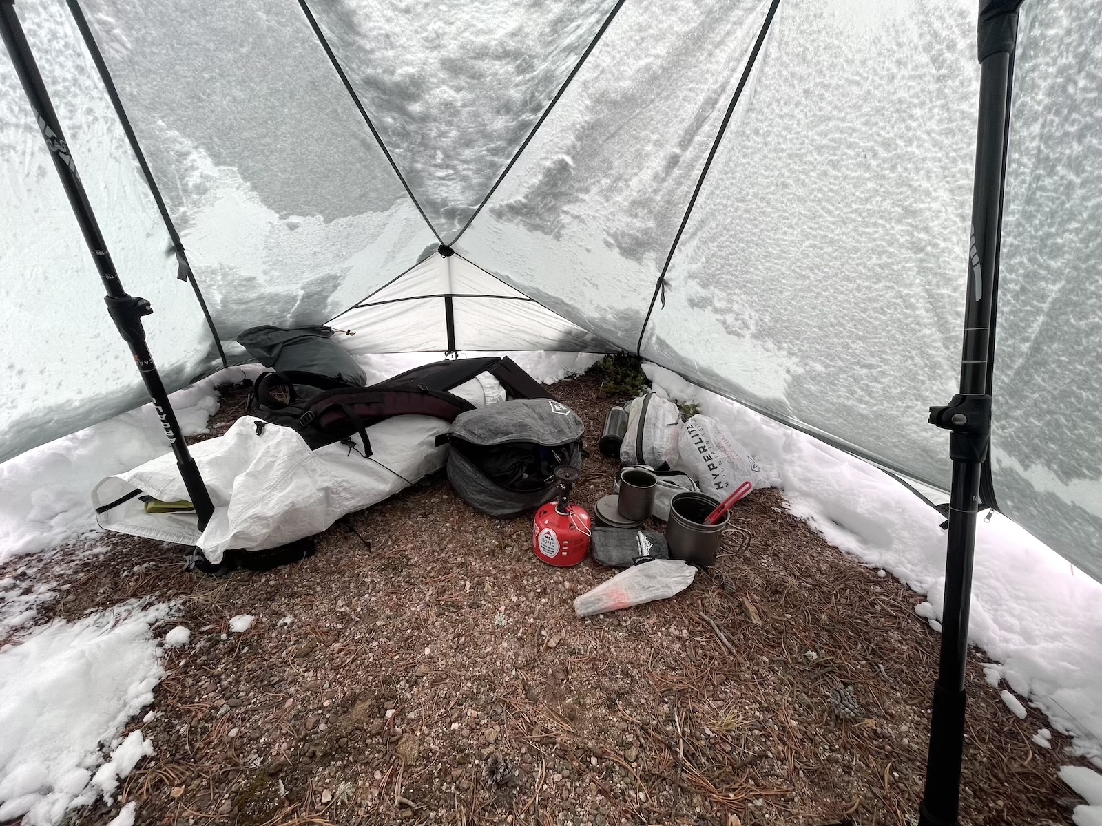 the inside of a tent with snow on the ground