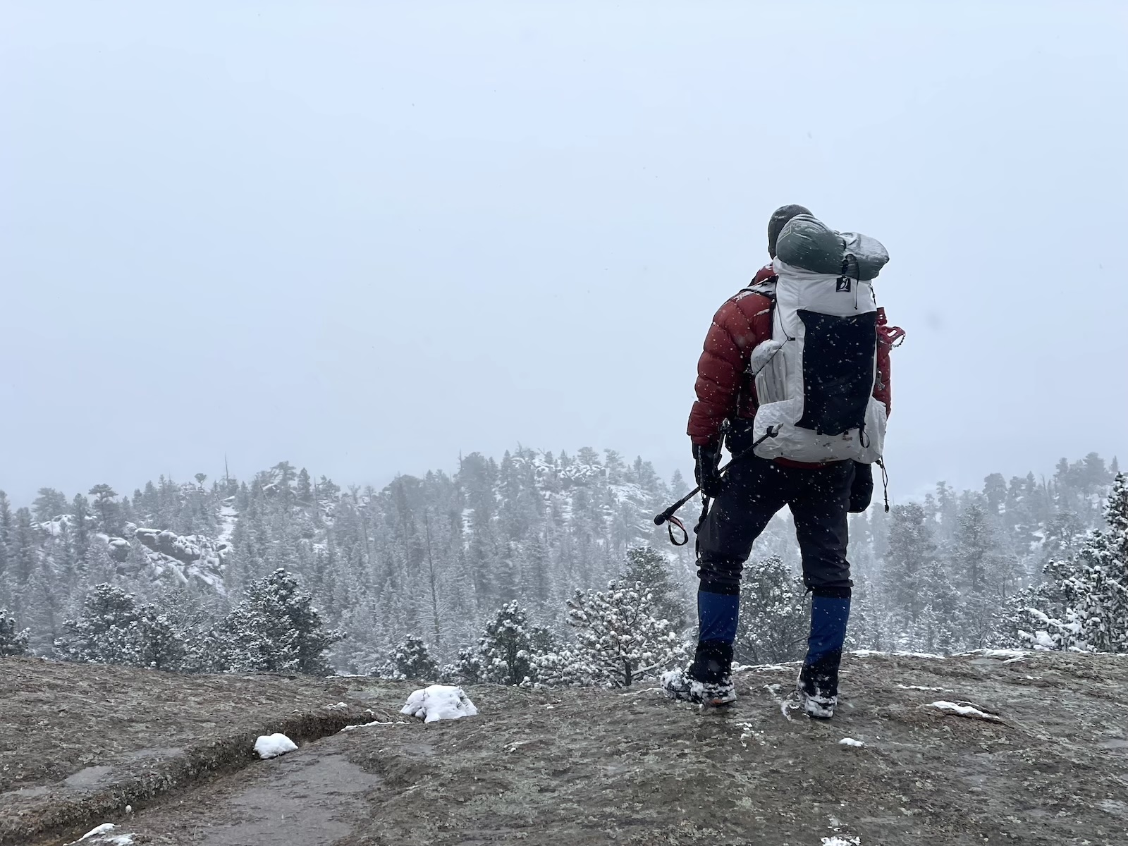 a man standing on top of a snow covered mountain