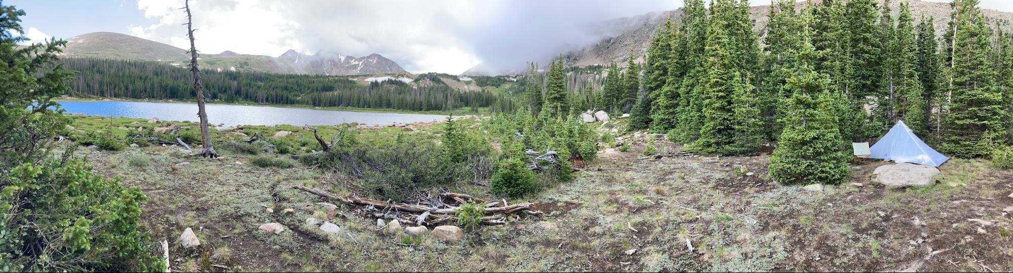 a lake surrounded by trees and mountains