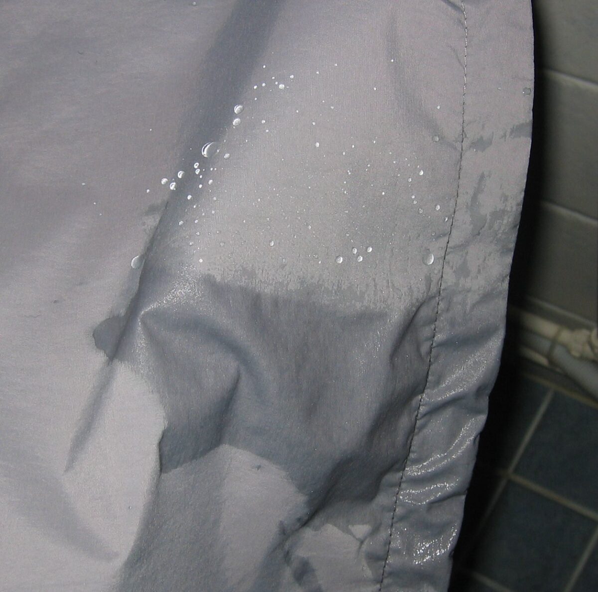 a close up of a person's shirt with water on it