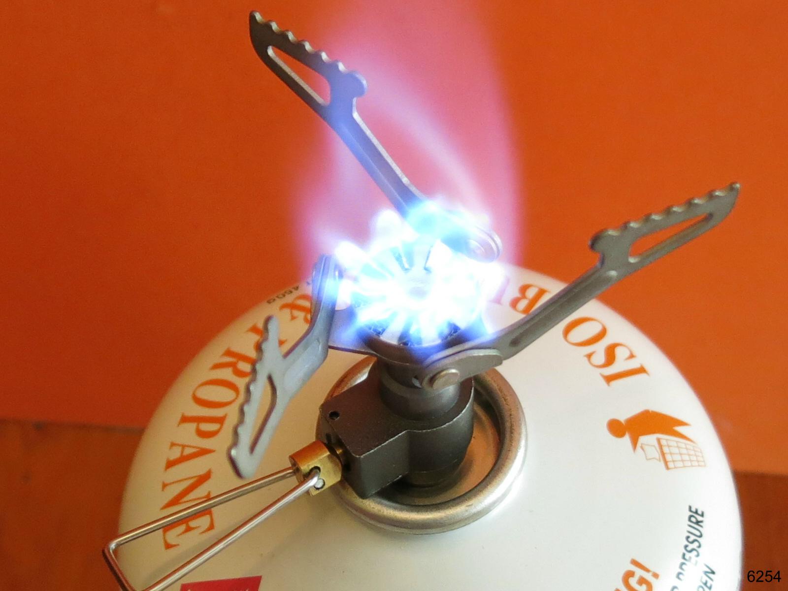 a close up of a metal object with a flame coming out of it