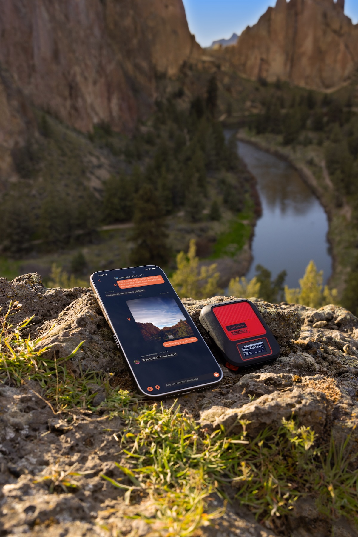 Garmin inReach Messenger Plus and a smartphone with a river canyon in the background.