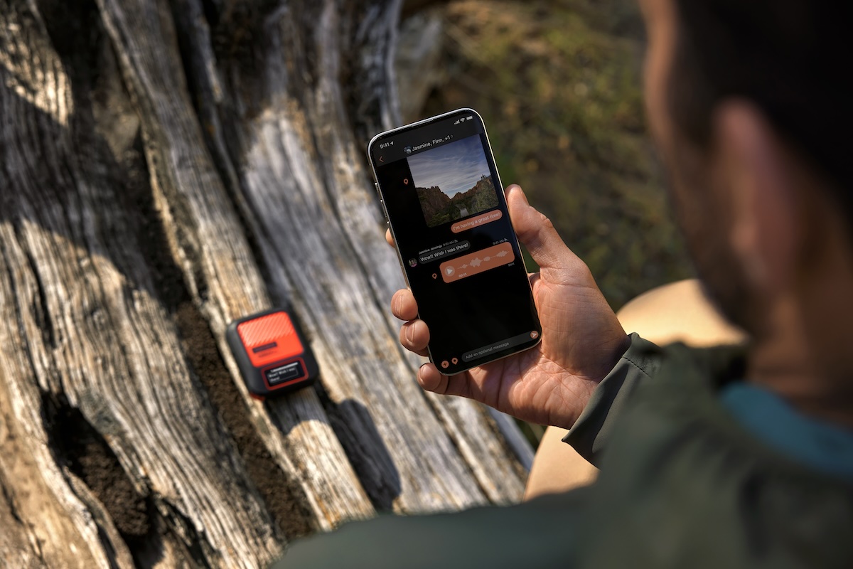 man holding a smartphone while transmitting a photo and voice memo via the garmin inreach messenger plus