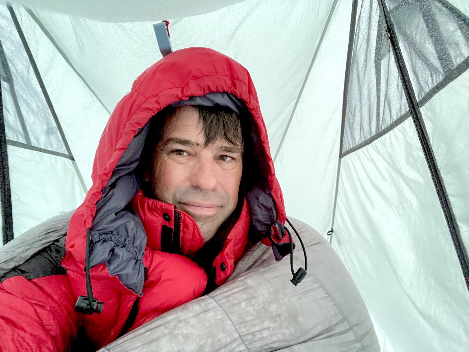 Ryan in a quilt inside a tent