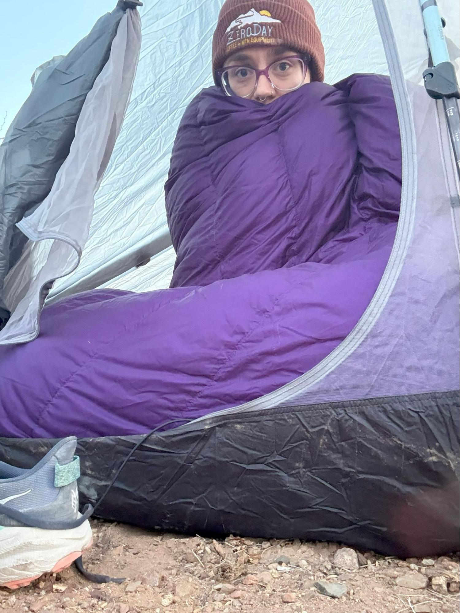 nikki in a tent with her alphalight quilt