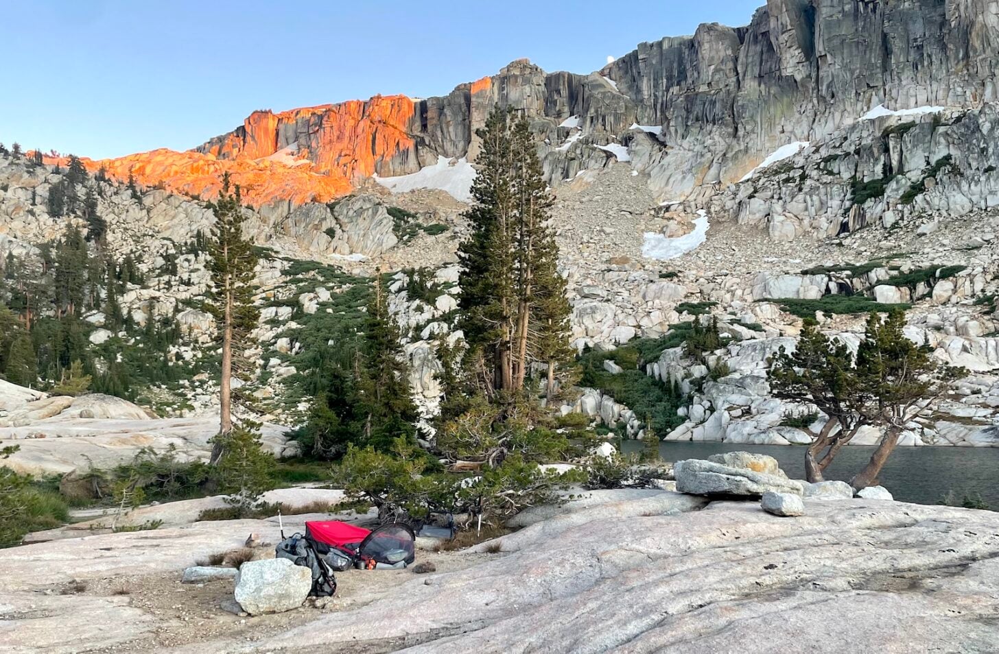 bivy sack camp next to a lake in the mountains