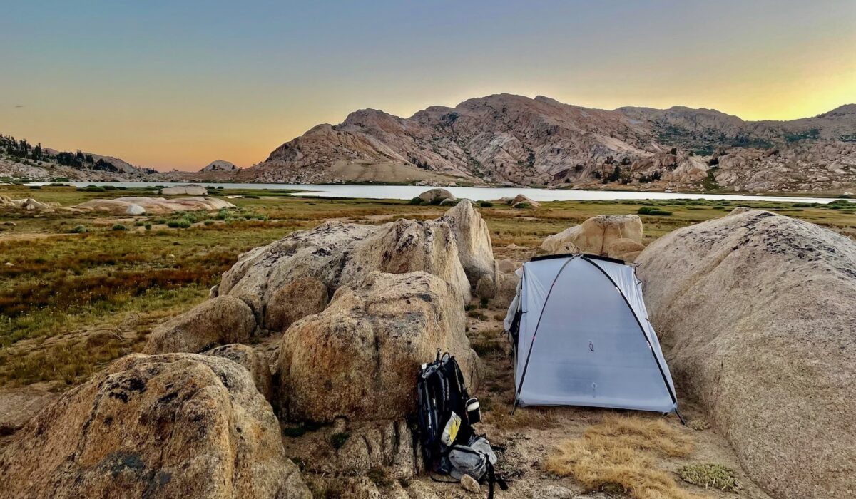 a tent tucked between two rocks