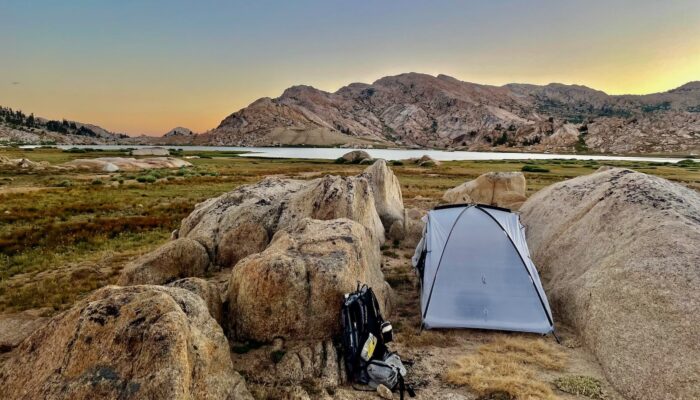 a tent tucked between two rocks
