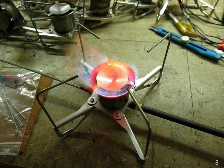 Prototype remote canister stove operating with a red-hot burner head.