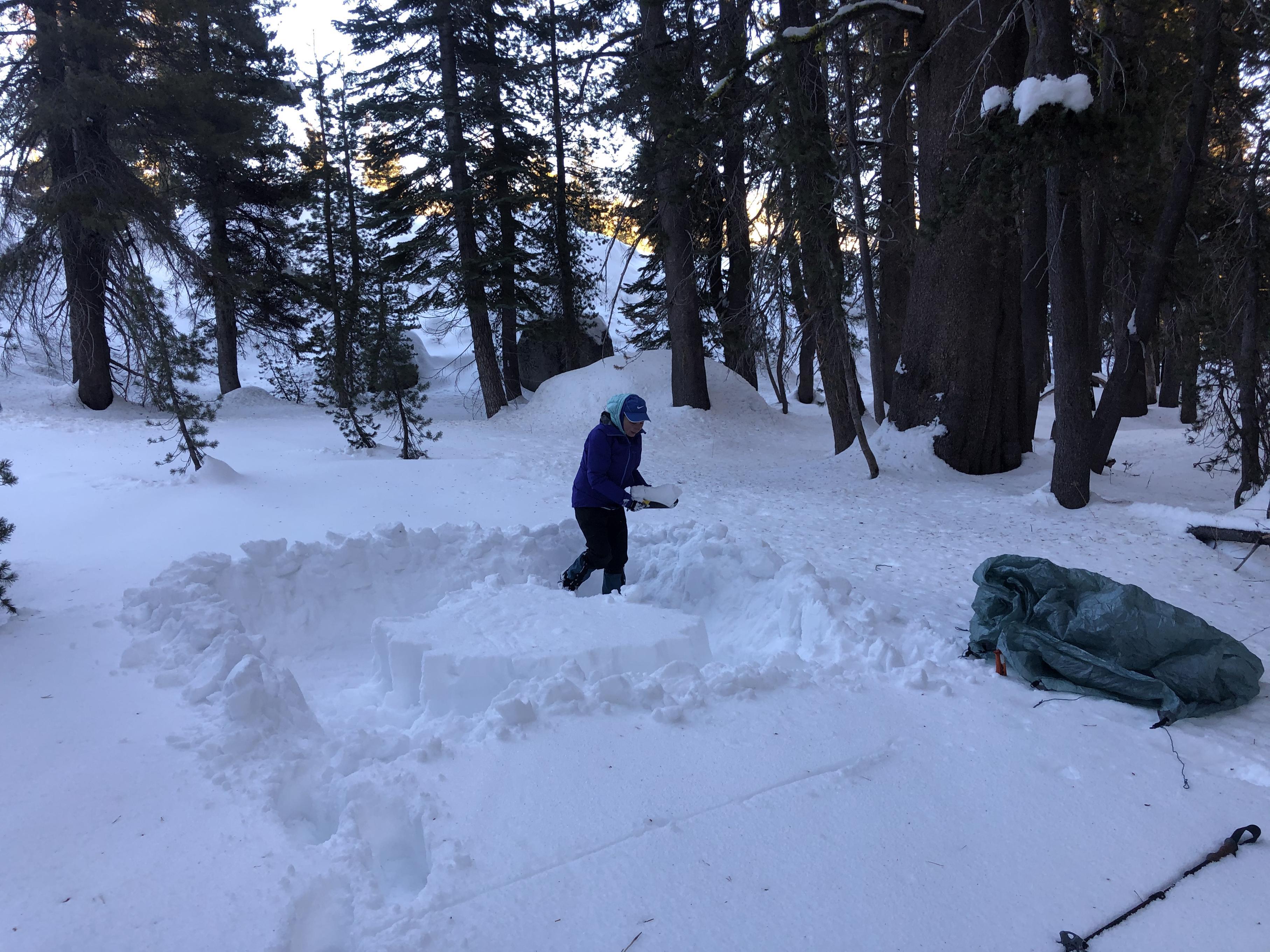 Gela preparing camp site for tent